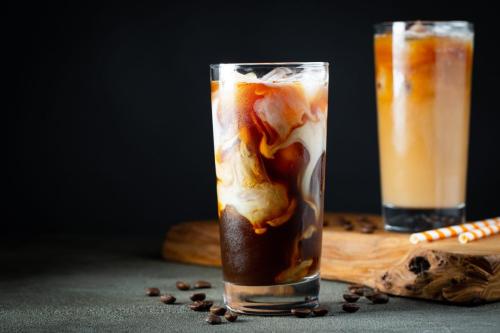 Ice,Coffee,In,A,Tall,Glass,With,Cream,Poured,Over,