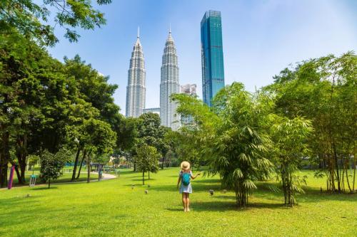 woman standing front of twin tower